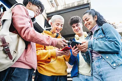 Friends with mobile phones outside The Link Minneapolis