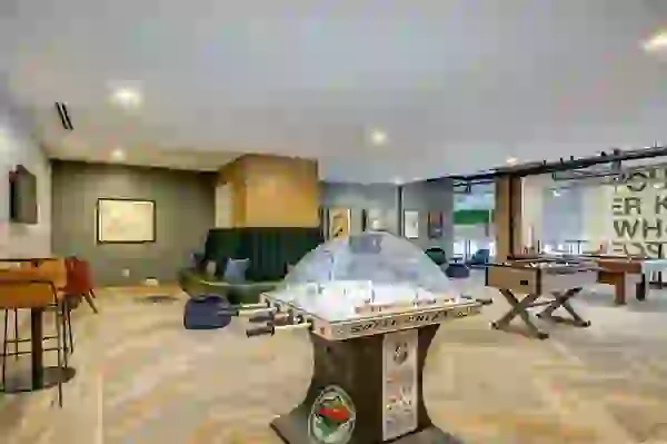 Game Room with hockey table, mounted TV, and lounge seating