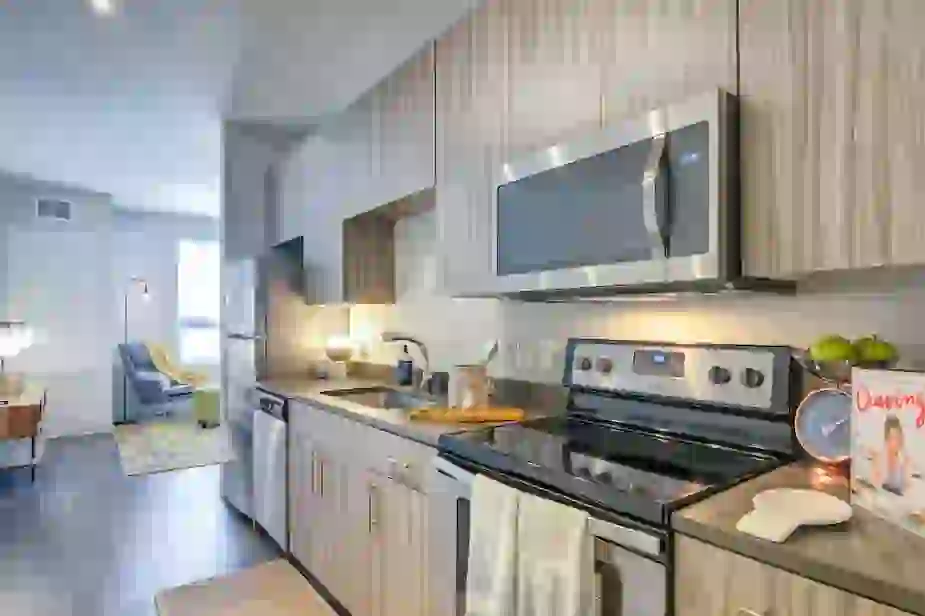 Kitchen showing washed wood style cabinetry and stainless steel appliances