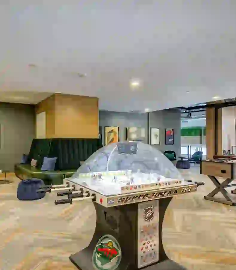 Game room with table hockey, foosball, and lounge seating
